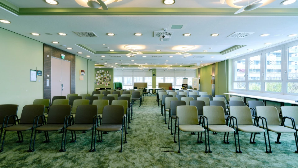 Heller Meetingraum mit Blick auf die Fensterfront, moderner Beleuchtung und Technik im Smartvillage Bogenhausen.